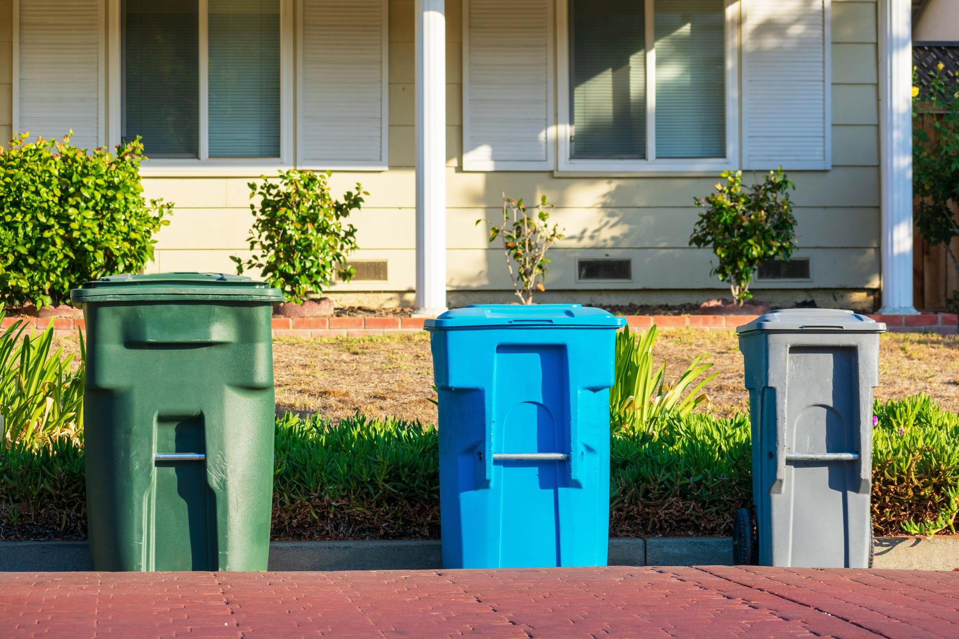 Compost, recycling and garbage carts set outside